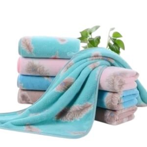 Blue and rose styled leaf print towels neatly folded on a minimalist bathroom shelf showcasing nature-inspired towel designs available online in India