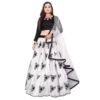 Woman wearing a black and white lehenga choli with floral printed skirt, long sleeve blouse, and sheer dupatta styled for festive and wedding occasions